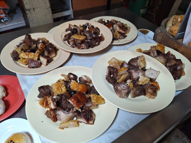 หมูย่างเมืองตรังหนังกรอบหลายจานบนโต๊ะ
